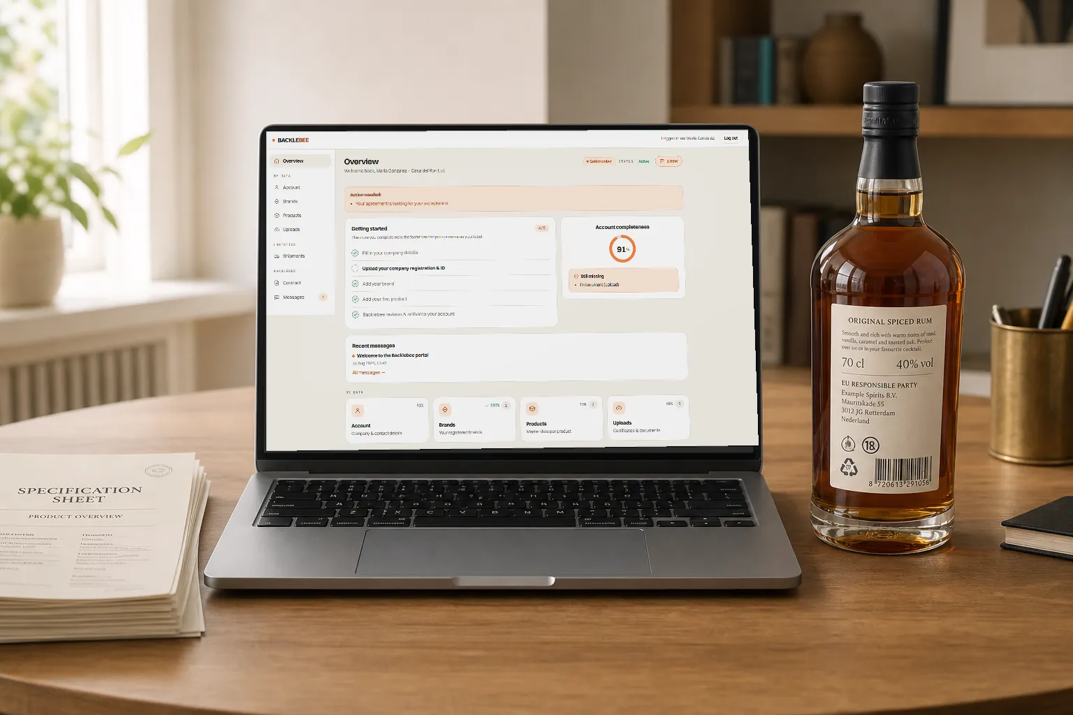 The partner portal on a laptop, next to the bottle and its specification sheet